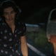 Two teens who've just hit...something with their car stumble at the roadside in I Know What You Did Last Summer.
